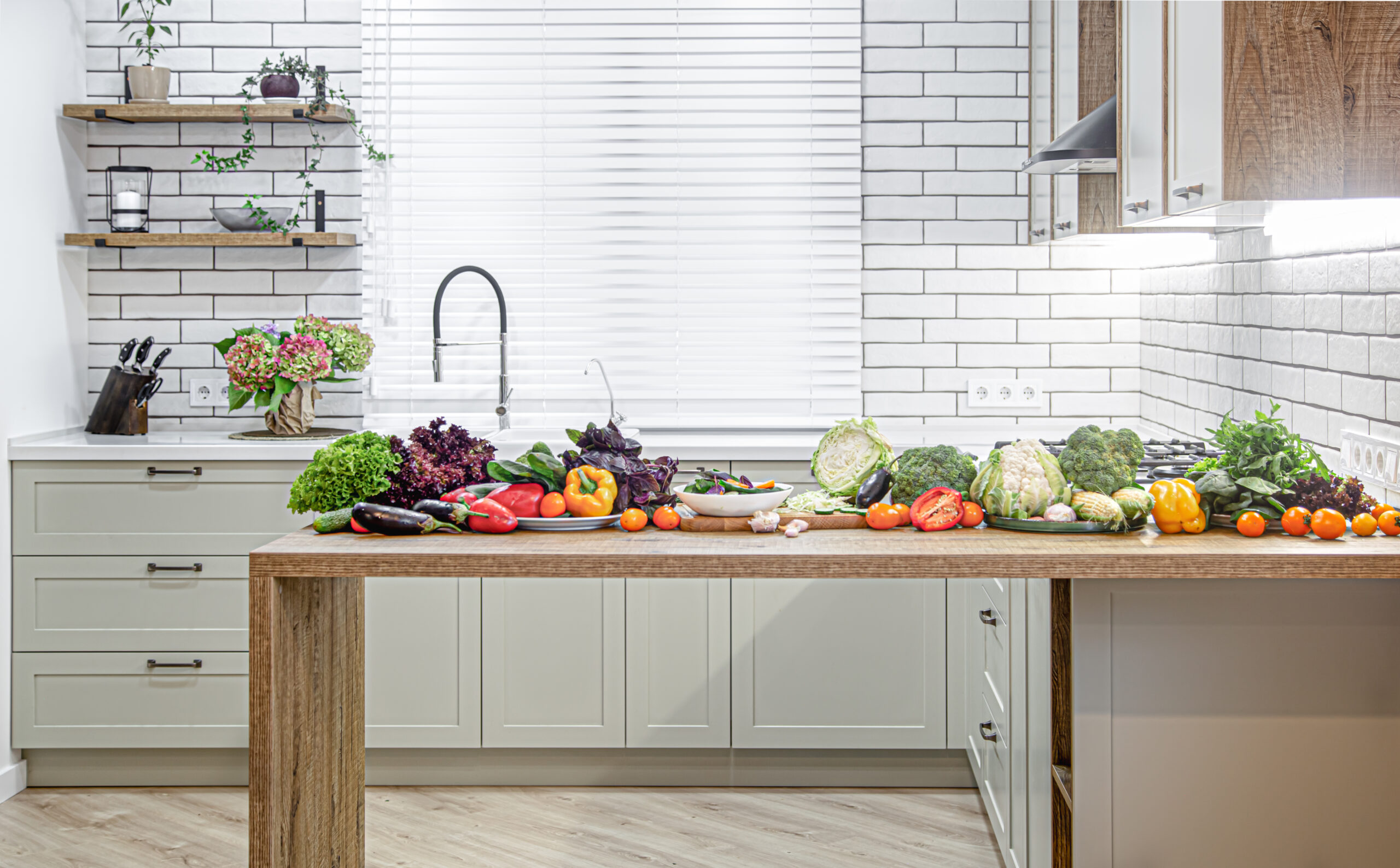 various vegetables wooden table against background modern kitchen interior scaled